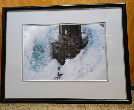 Lighthouse on the High Seas Framed Print