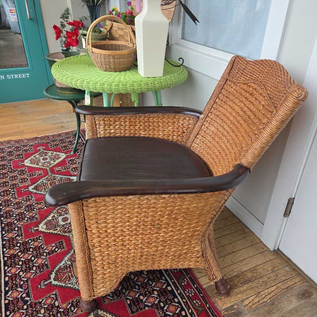 Vintage Wicker Arm Chair with Dark Wood Accents and Brown Leather Cushion